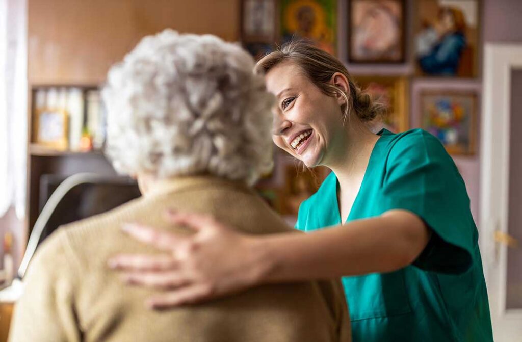 Older adults and family members tour a bright assisted living lounge with accessible seating and safety rails.