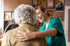 Older adults and family members tour a bright assisted living lounge with accessible seating and safety rails.