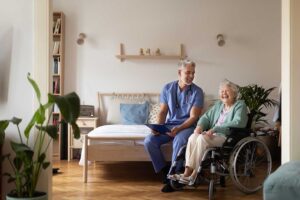 Older adults walk safely through a bright assisted living hallway with handrails and clear pathways.